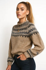 Woman wearing a beige knit sweater with multicolor Nordic pattern