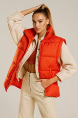 Women's orange puffer vest with beige fleece jacket casual winter style